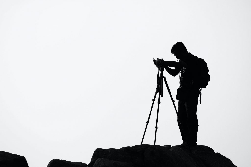 Backpacking with Bacon | silhouette of travel blogger taking photo